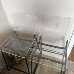 two acrylic chairs 