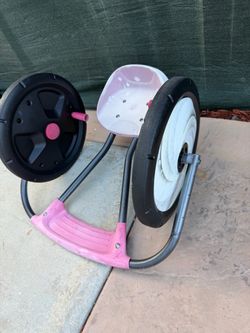 Radio Flyer Cyclone arm-powered ride-on toy, featuring a pink seat and ergonomic design for comfort.
