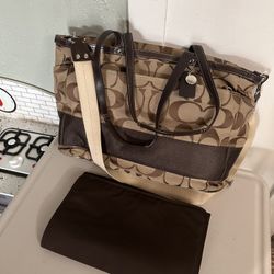 Large Coach diaper bag—it is like new. I only used it once; it is clean, stain-free, and has no damage whatsoever. It looks brand new.