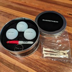 Titleist Collectors Tin Pro V1 Set - Guggenheim New. Comes with 5 tees, ball marker, mini sharpie, and 3 Pro V1s with Guggenheim logo.

