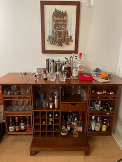Expandable bar cabinet in classic cherry finish