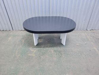 Oval black coffee table with white legs