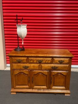 Antique sideboard with decorative lamp