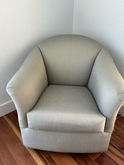Grey Swivel Chair.  Measures 34” wide, by 34” tall, by 34” deep.