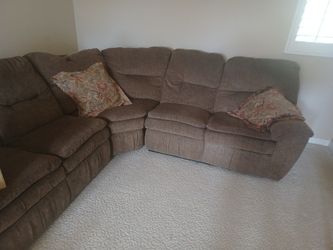 Brown Sectional Reclines On One End.