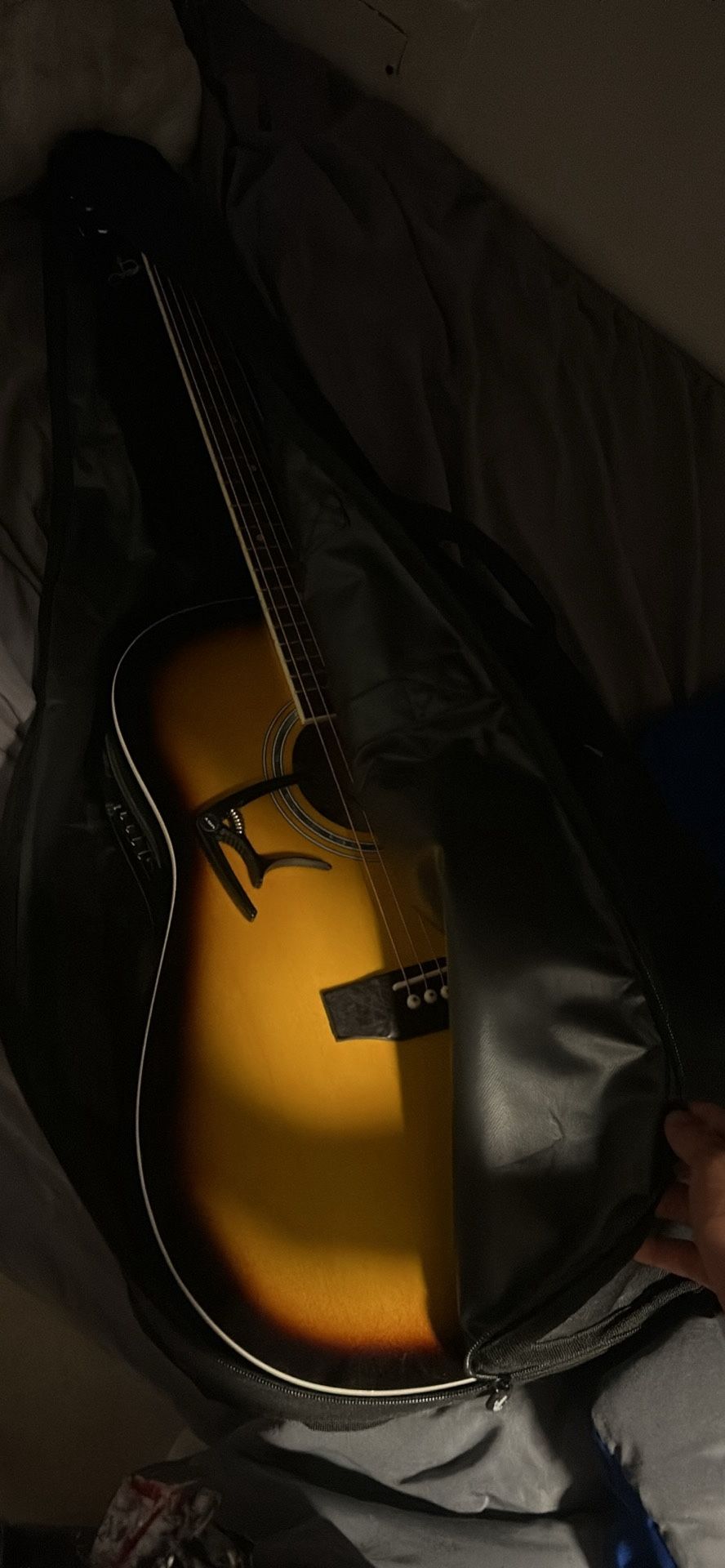 Acoustic guitar and capo and guitar bag