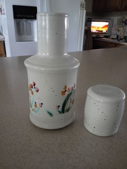 Hand-painted pottery carafe with cup/lid.