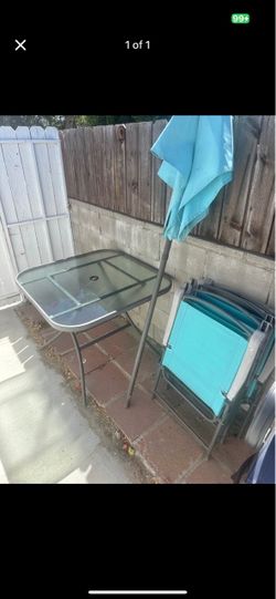 Outdoor table with 4 chairs and umbrella
