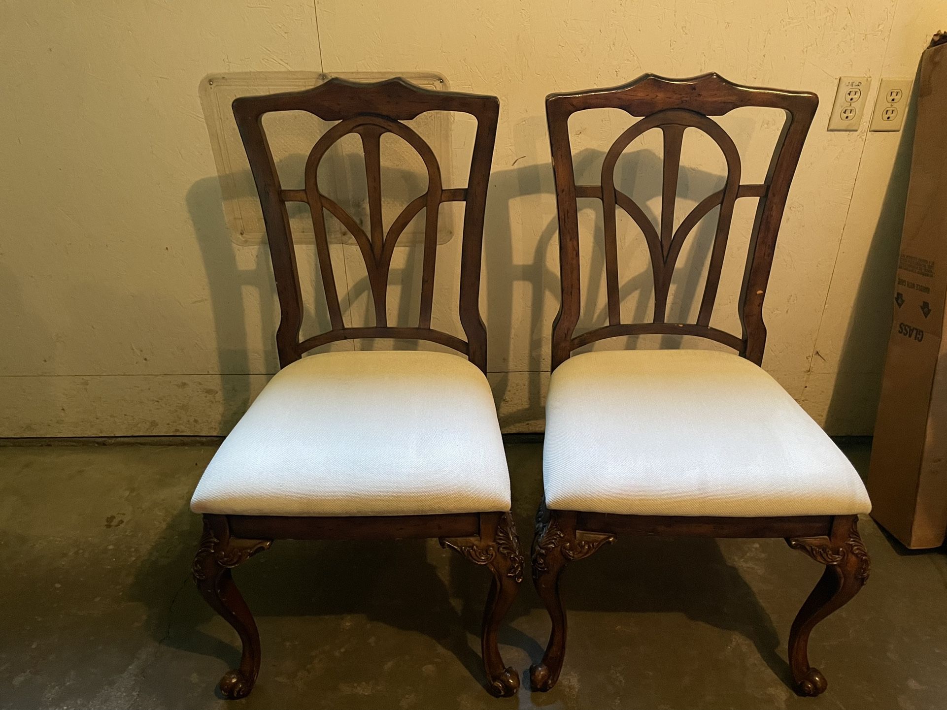 Two Wood Chairs With White Upholstered Seat