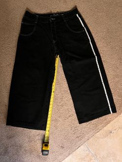 JNCO black jeans with white stripe and skunk patch