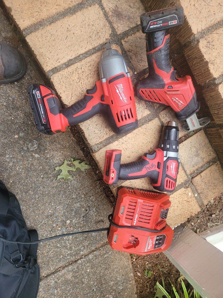 Milwaukee 1/2 Inch Impact Wrench; Drill; Sawsaw And Charger