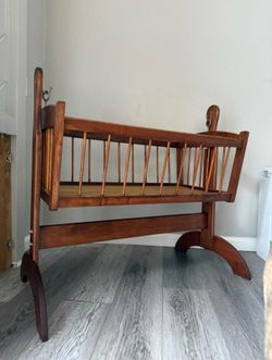 Vintage wooden swinging baby cradle