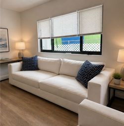 White sofa and 2 matching single seat chairs