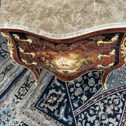  Curio Louis XV Commode LOOK UP This is a French-style marble-topped commode with gold details. TIME PERIOD 20th Century ORIGIN France  HISTORY This c