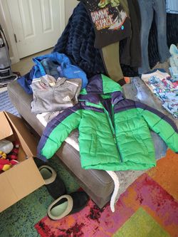Kids Green puffer jacket and several outfits