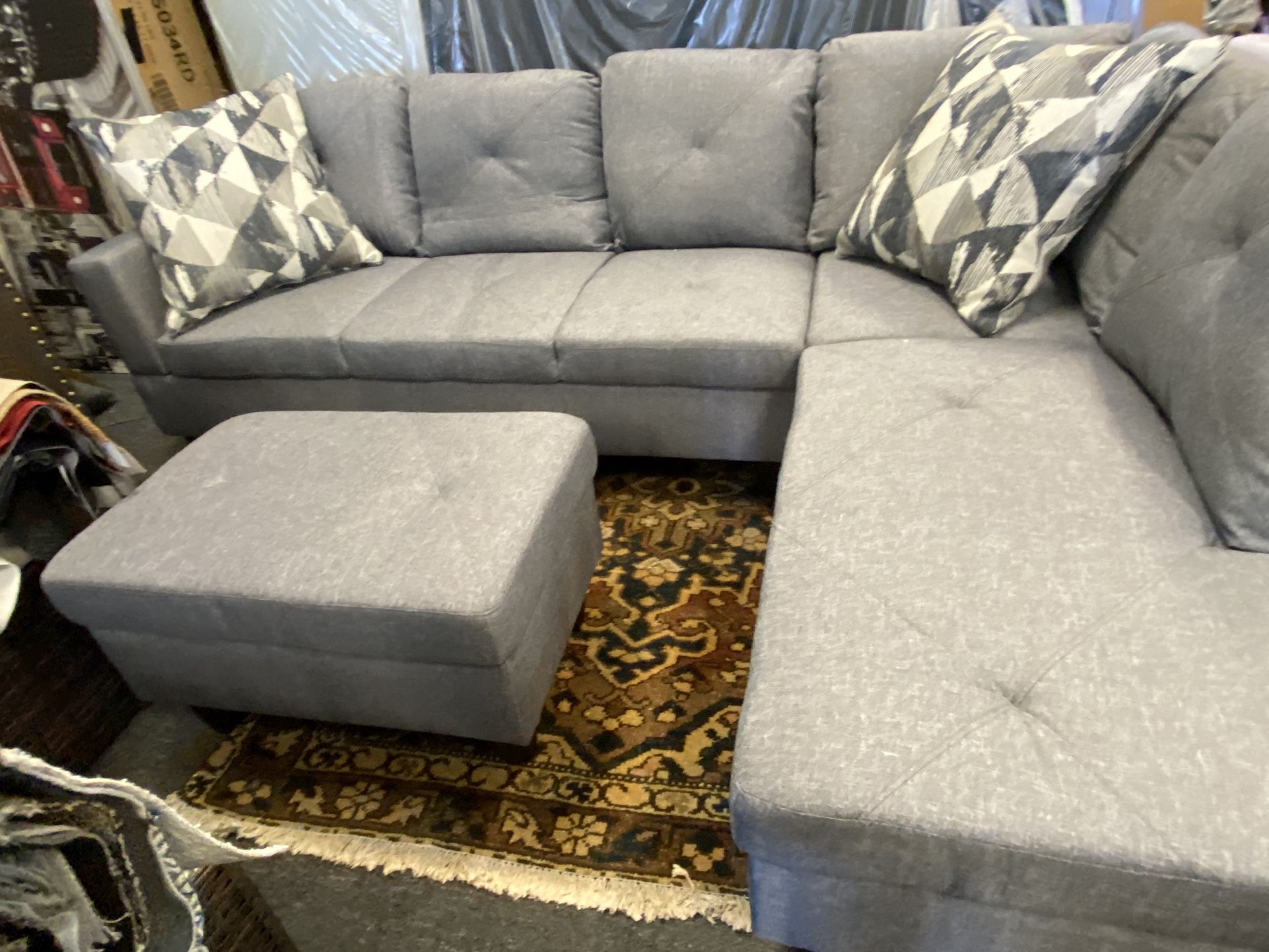 New Grey Sectional. With Free Ottoman Sells For $899