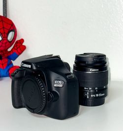 Canon EOS 4000D DSLR camera with 18-55mm lens and charger