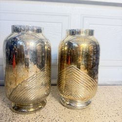 mercury glass with a silver or gold finish and have a distinctive etched linear pattern.