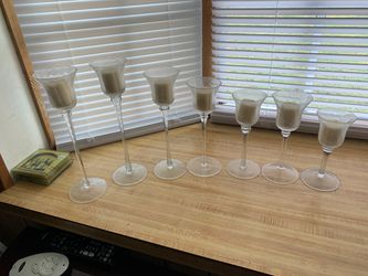 Assorted sizes of candle holders with candles.