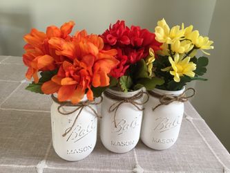 Distressed mason jars with silk flowers $15 for 3