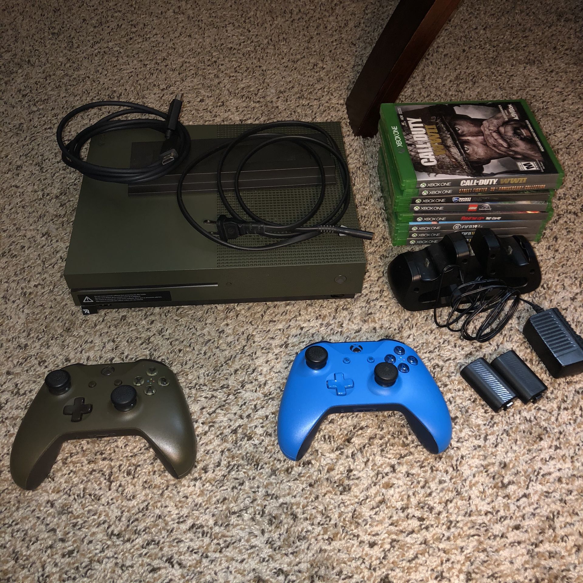 Xbox One S 1TB with 2 controllers, charging station, and 8 games