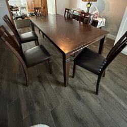 Dark Brown wood dining table Includes 6 cushioned chairs 