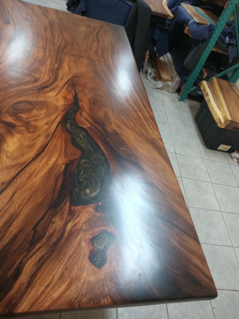 monkey pod table fine finish. carcks holes with black and gold flaers