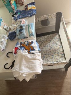 Brand new baby clothes and toddler bed