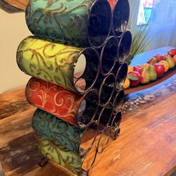 Pier 1 embossed metal wine rack in earth tones like teal, green, and Tuscan orange