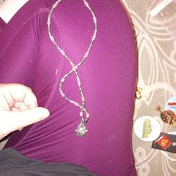 sterling silver Disney castle charm attached to a beaded  necklace. 