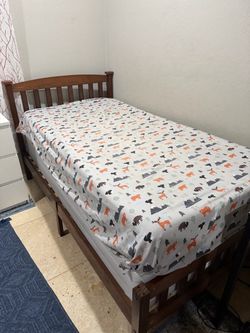 Twin size bed frame with mattress.