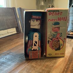 “Peace Corps Man” Wind Up Toy