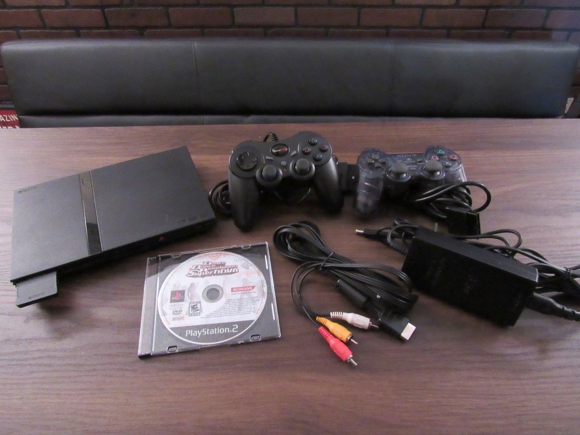 Sony PlayStation 2 w/ 2 controllers, 2 dance pads, and game