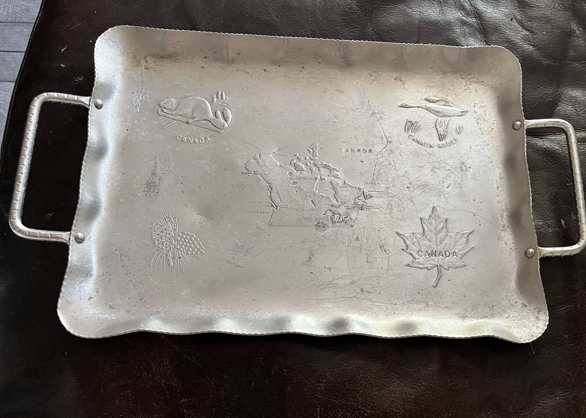vintage Wendell August Forge aluminum tray depicting a map of Canada with various Canadian symbols