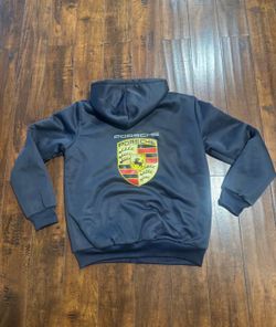 Porsche 911 Motorsport Zip-Up Hoodie Jacket - Porsche logo 	•	Color: Dark blue / navy exterior with light gray fleece lining inside  	•	Length: 27 inc