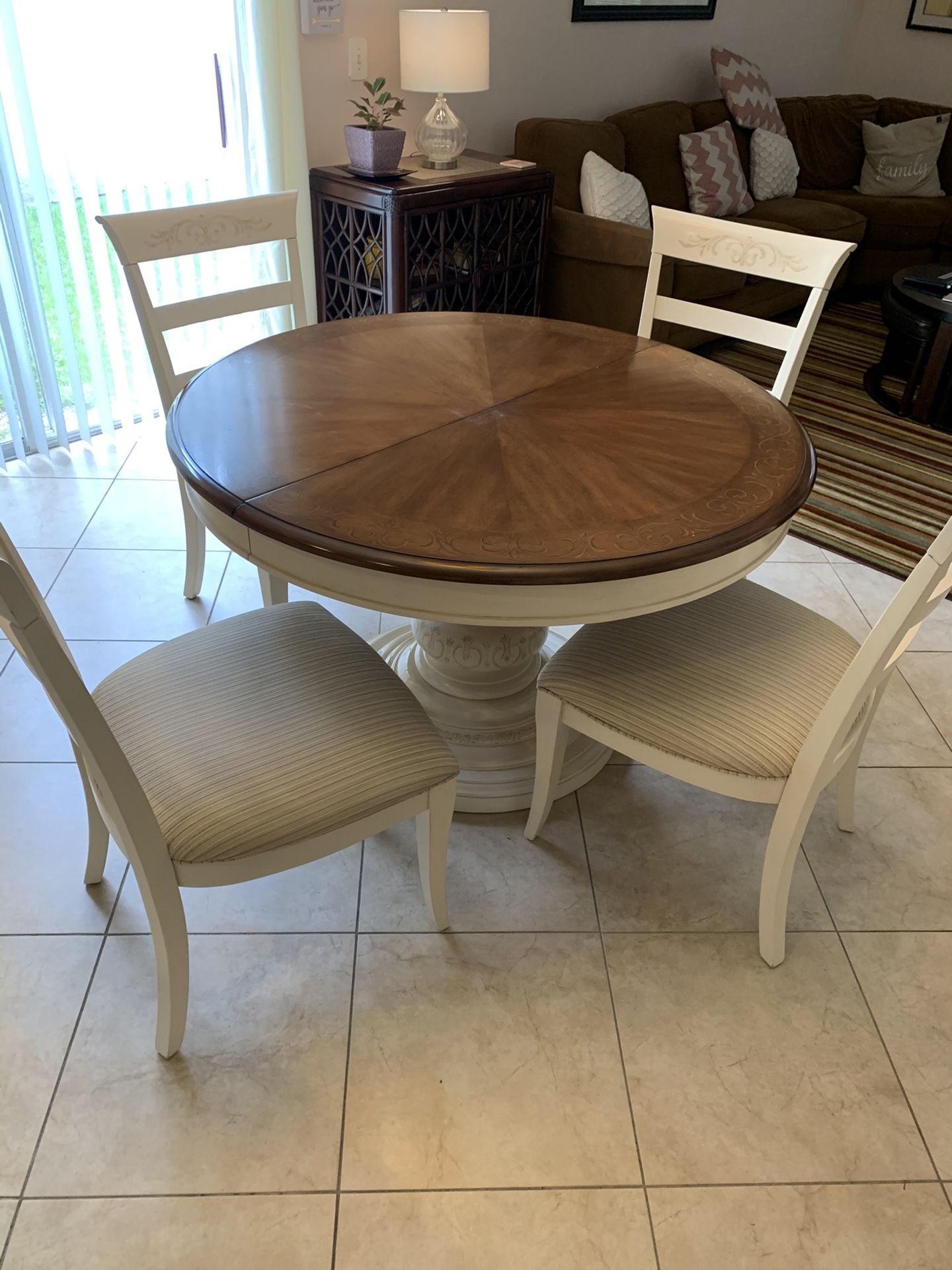 Round kitchen table with four chairs with extension table to fix six. Priced to sell.