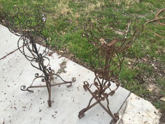 Two Vintage ornate iron plant stands.