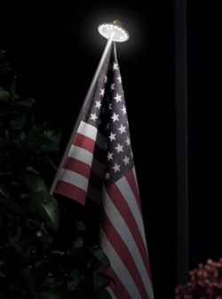 American flag - Brand new - comes with pole and solar light. With installation at your place