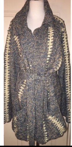 This is a true hippie jacket cardigan sweater made by kennington. There are no rips or TEARS. It also has two pockets on the on the front of the jack