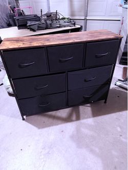 7-drawer dresser featuring a rustic brown wood top and a black metal frame with fabric bins