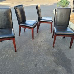 4 Faux Leather and Wood Dining Chairs Used 