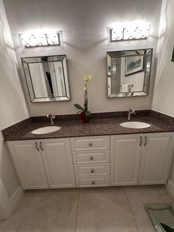 72" vanity with granite top. Kohler sinks,  brushed nickel faucets/hardware, 2 mirrors and 2 lighting fixtures
