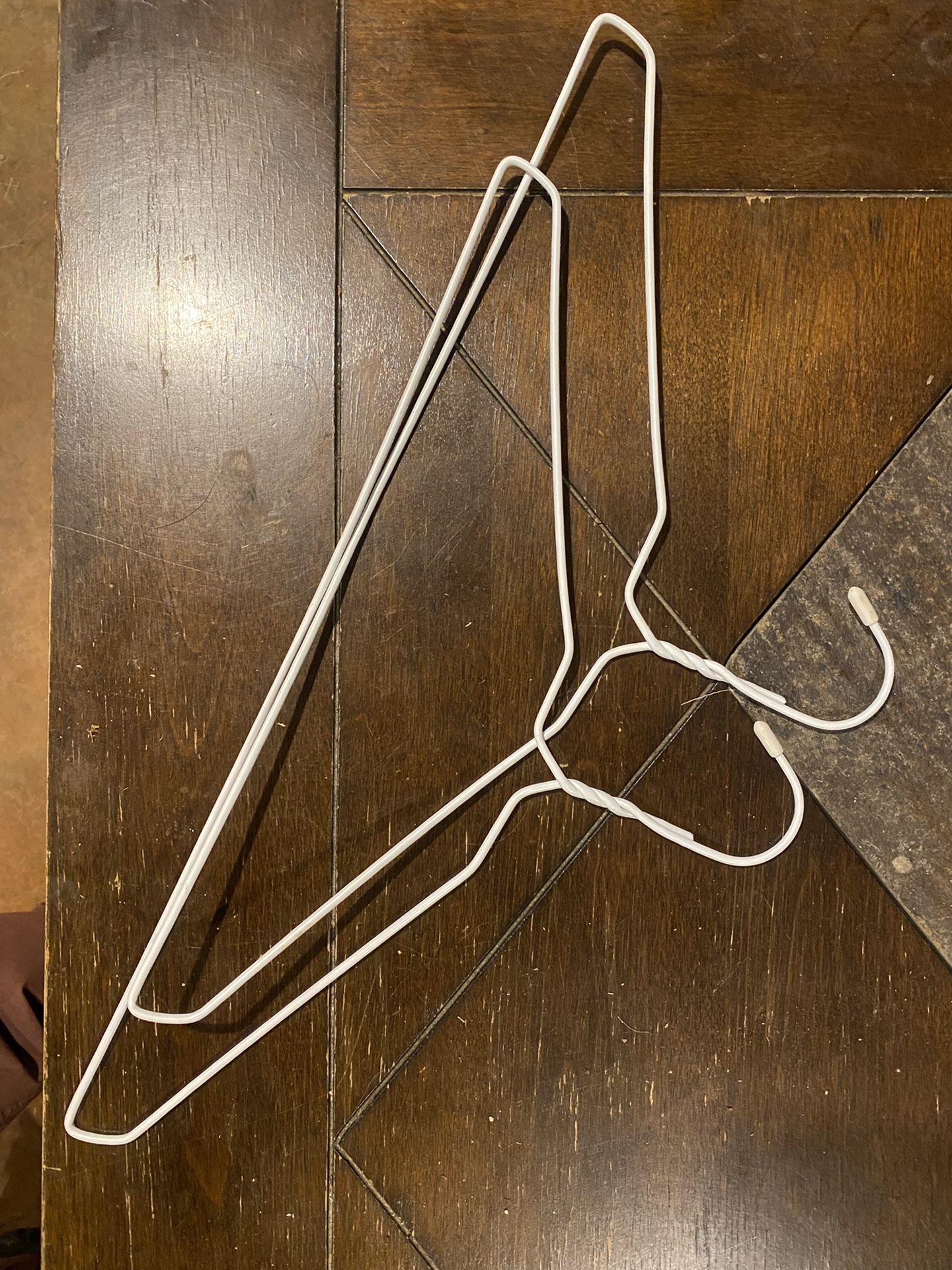 Two White Metal Hangers