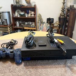 Sony PlayStation 2 Console - Black. It includes one controller, av cable, memory card. Everything is ready for games! Tested. Working great.