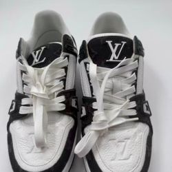 Louis Vuitton trainer in black and white color scheme, with low heel design.