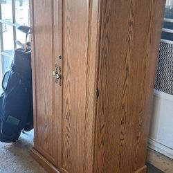 Oak Cabinet With Elegant Brass Handles