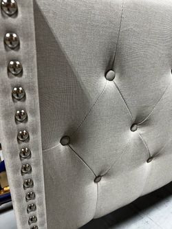 Tufted upholstered headboard with nailhead detailing + mattress