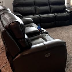 Comfortable Dark Brown leather reclining sofa with center console.  
