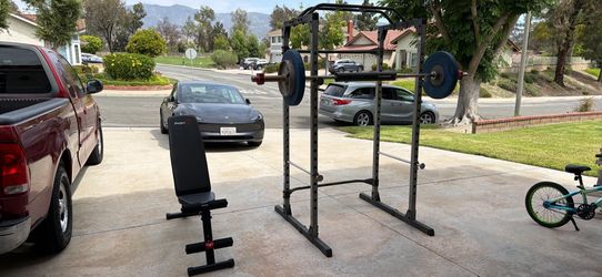 Power rack with barbell, plates and adjustable bench
