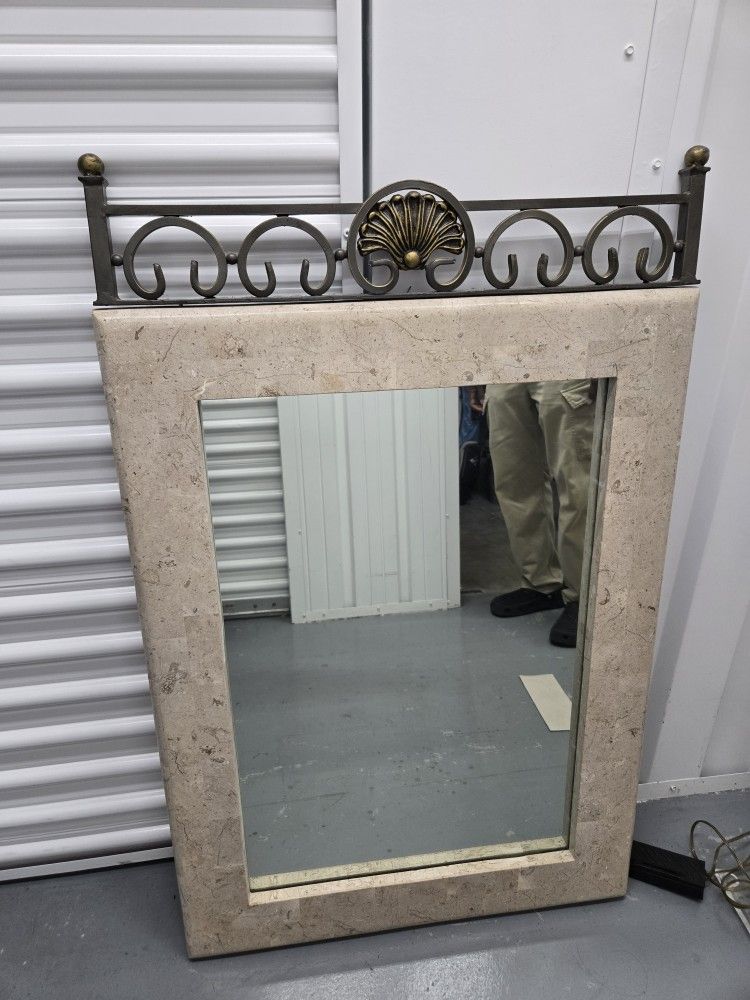Stone-look mirror with metal scrollwork